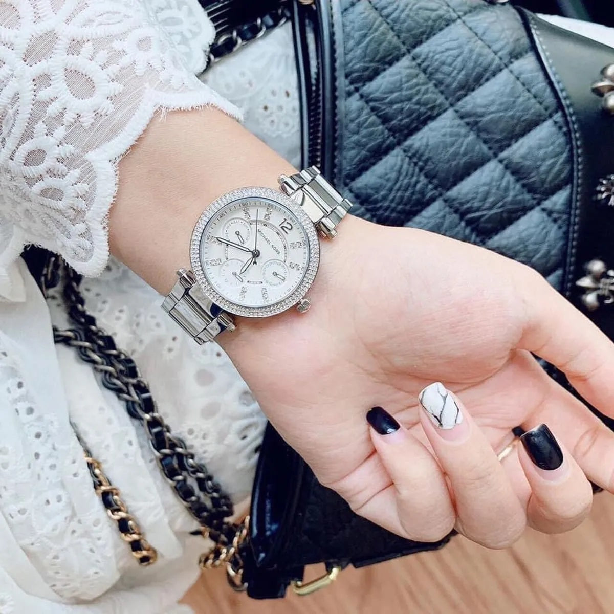 Michael Kors MK5615 women's silver stainless steel watch worn on wrist