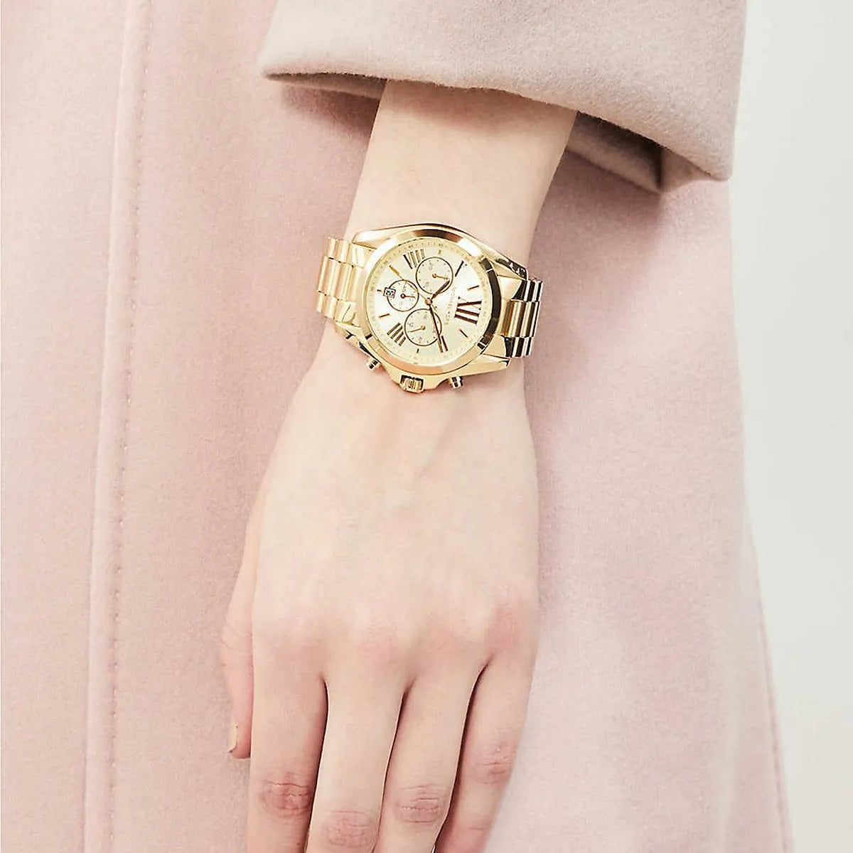 Michael Kors MK5605 women's gold watch worn on wrist showing full case and bracelet