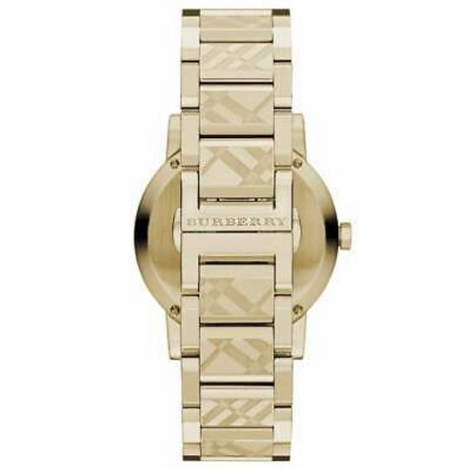 Detailed close-up of the side of the Burberry BU9234 watch, showing the textured crown and polished gold case finish.
