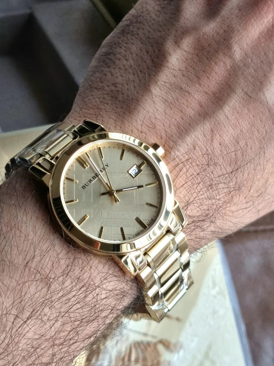 Burberry BU9033 gold watch worn on wrist – men’s The City 3 model