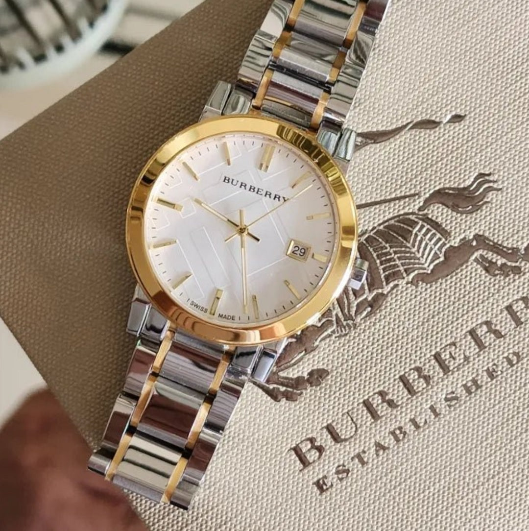 Glamour shot of Burberry BU9115 women’s watch with gold case and silver dial styling