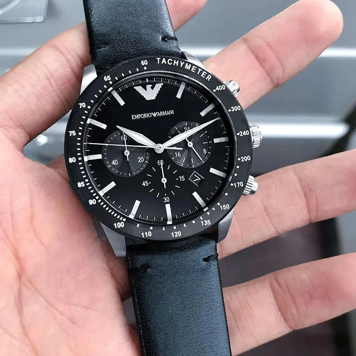 Emporio Armani AR11243 Mario men’s watch with black leather strap and black dial in hands