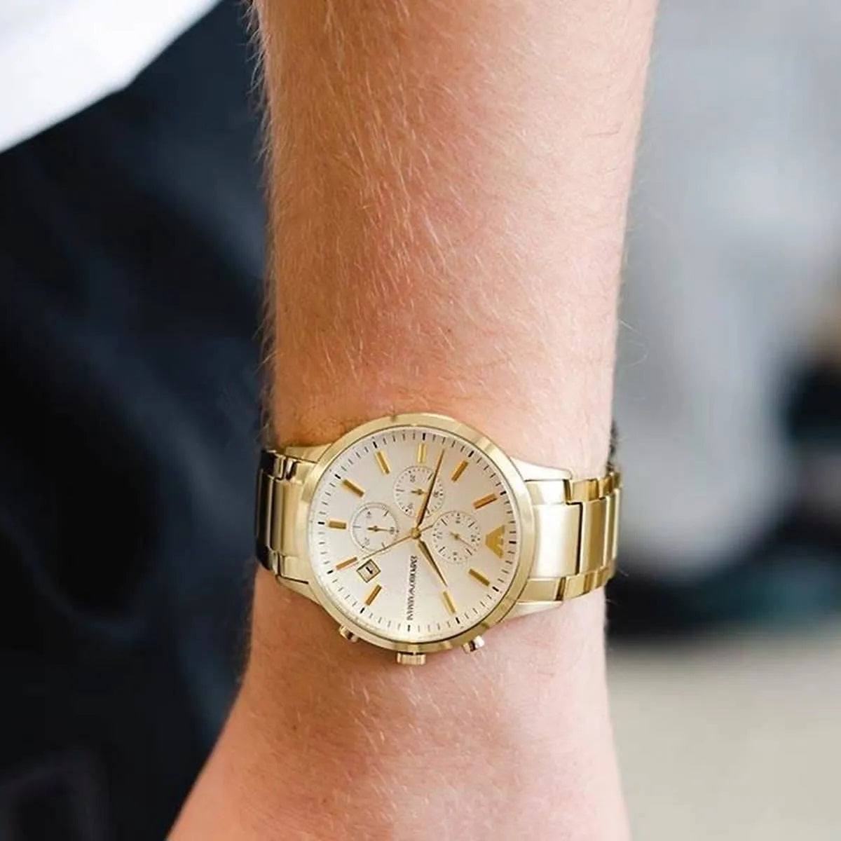 Wrist shot of Emporio Armani AR11332 showing full gold strap and silver dial
