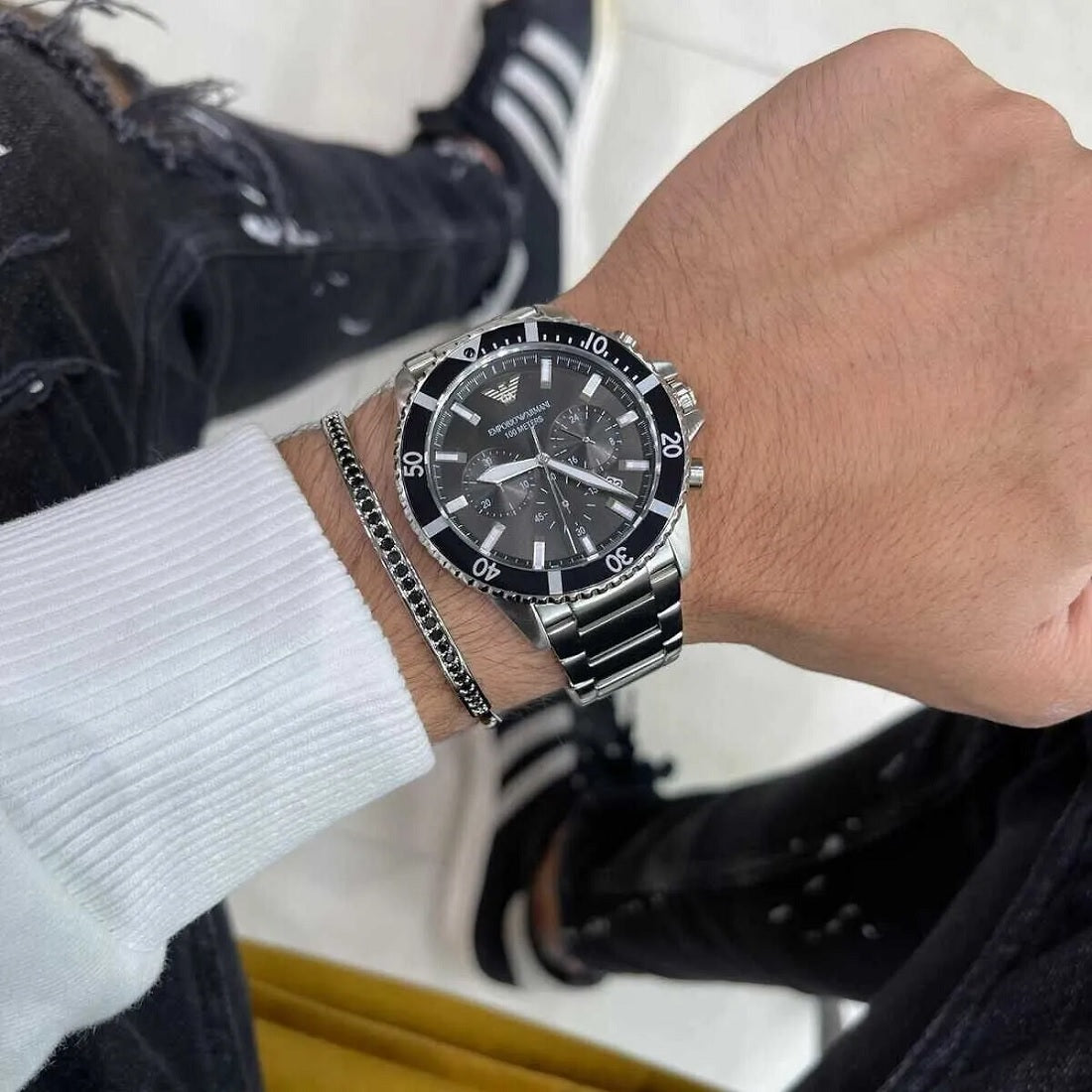 Close-up wrist view of Emporio Armani AR11360 with sharp black dial and steel bracelet