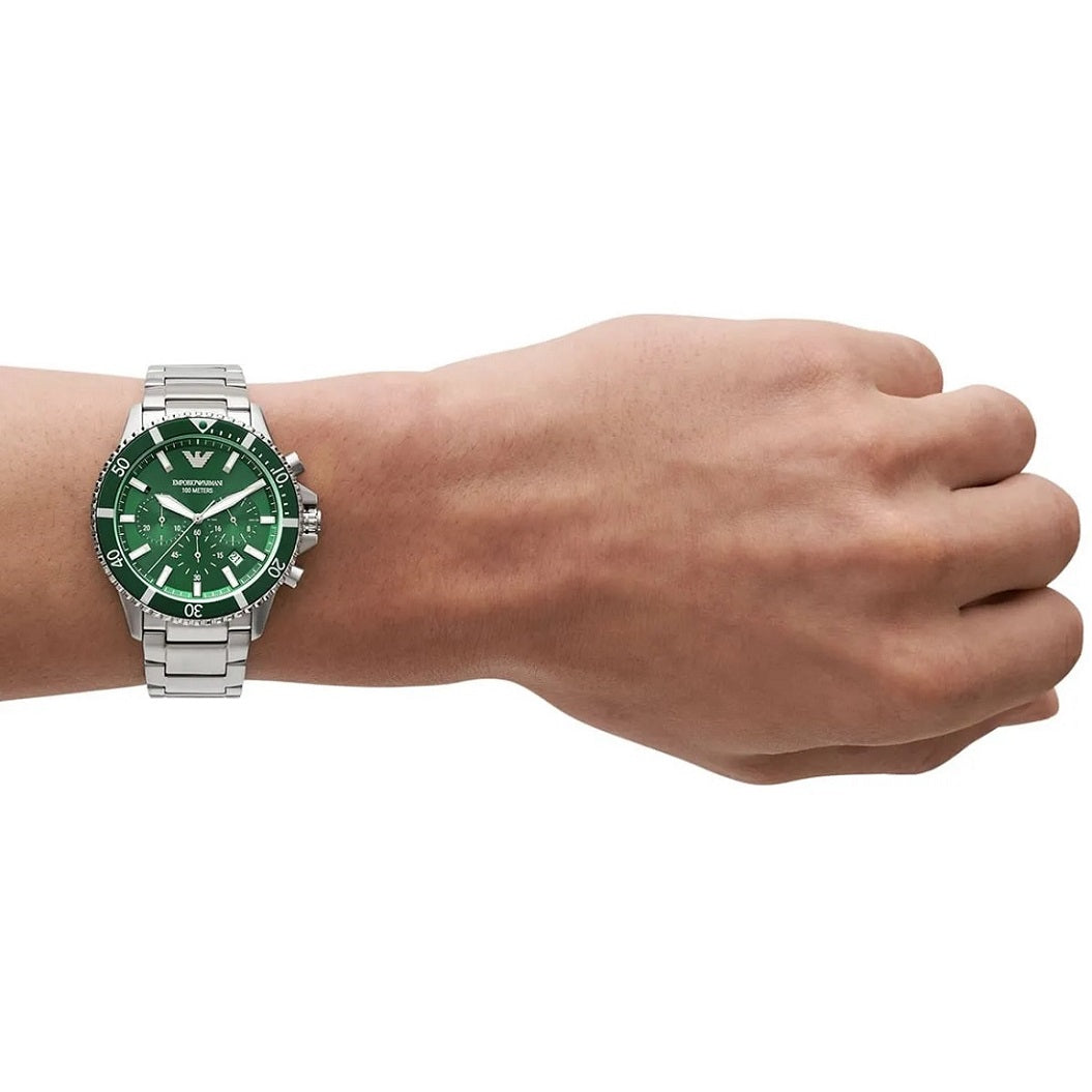 The Emporio Armani AR11500 diver watch with a green dial and silver strap on a man's wrist, showing its size and fit.