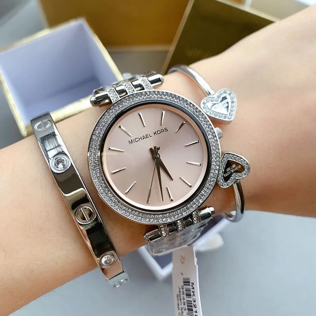 Michael Kors MK3218 silver watch worn on wrist with beige dial
