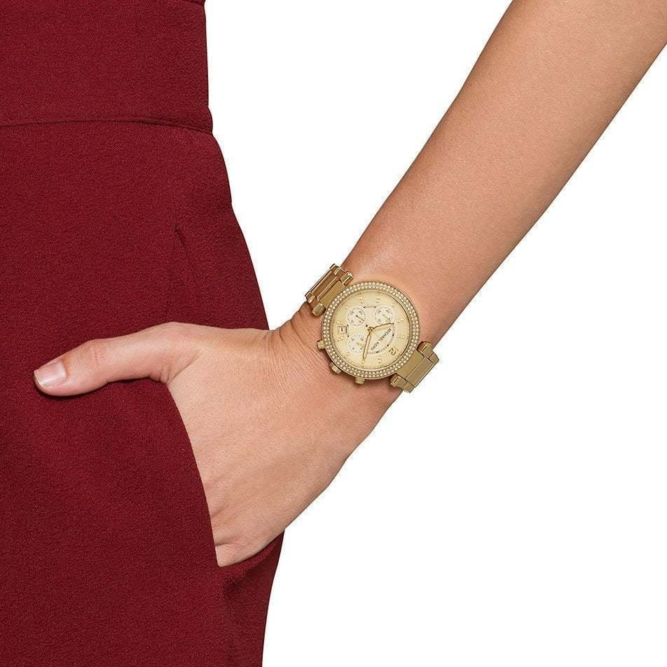 Wider wrist view of Michael Kors MK5354 showcasing bold all-gold design