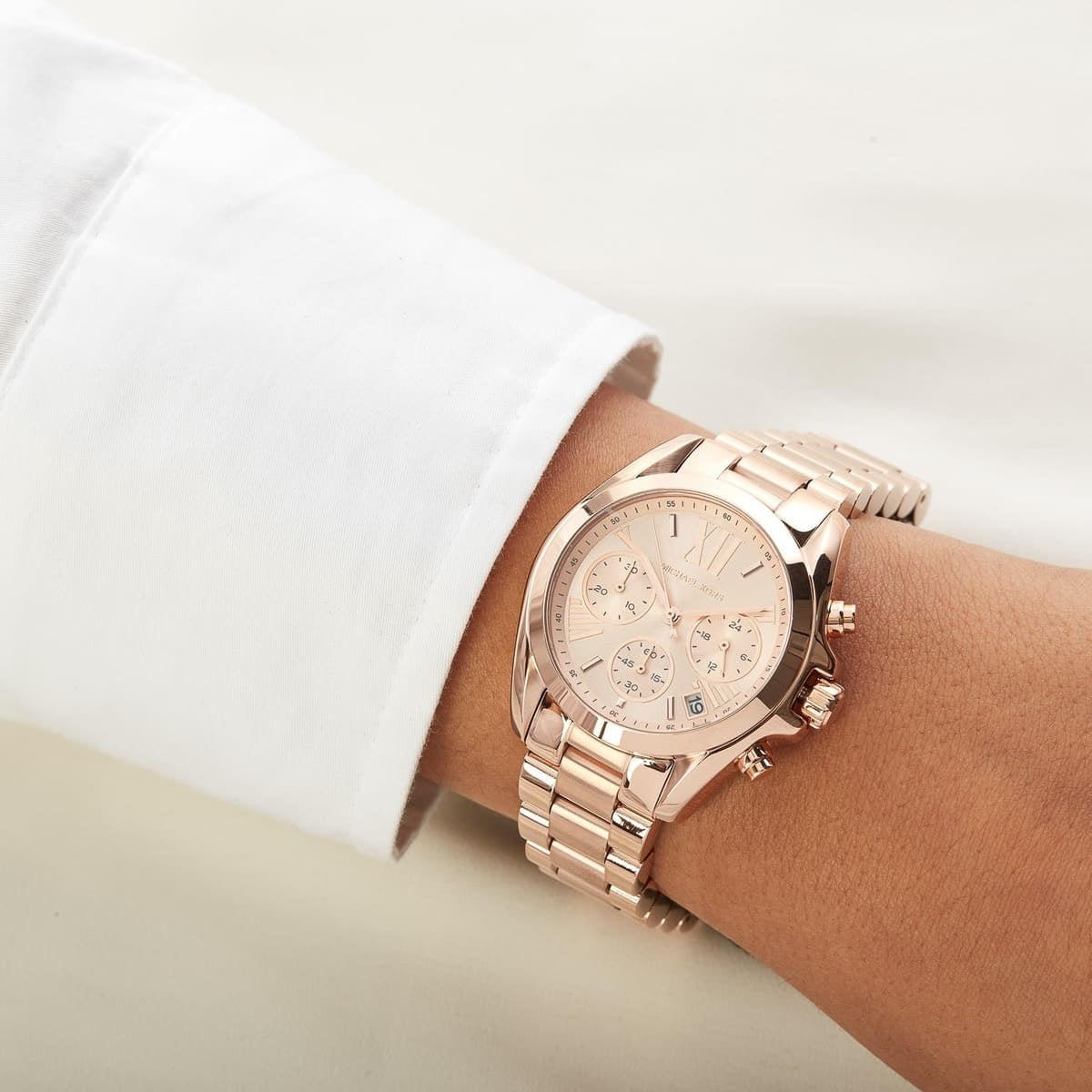 Close-up of Michael Kors MK5799 women's rose gold watch on wrist highlighting dial and finish