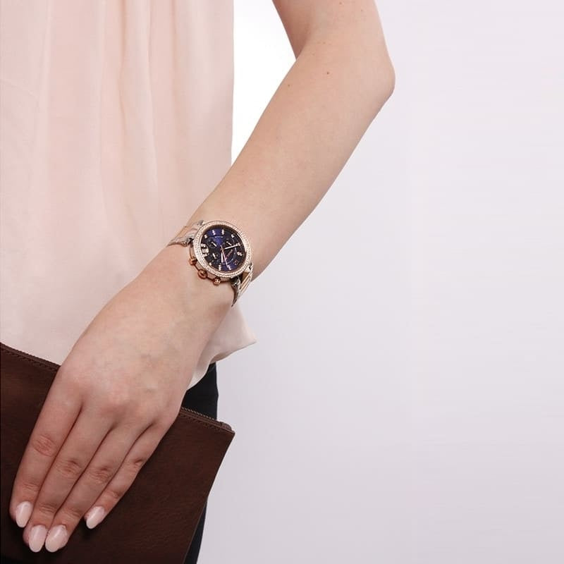 Michael Kors MK6141 women's two-tone watch with blue dial worn on wrist
