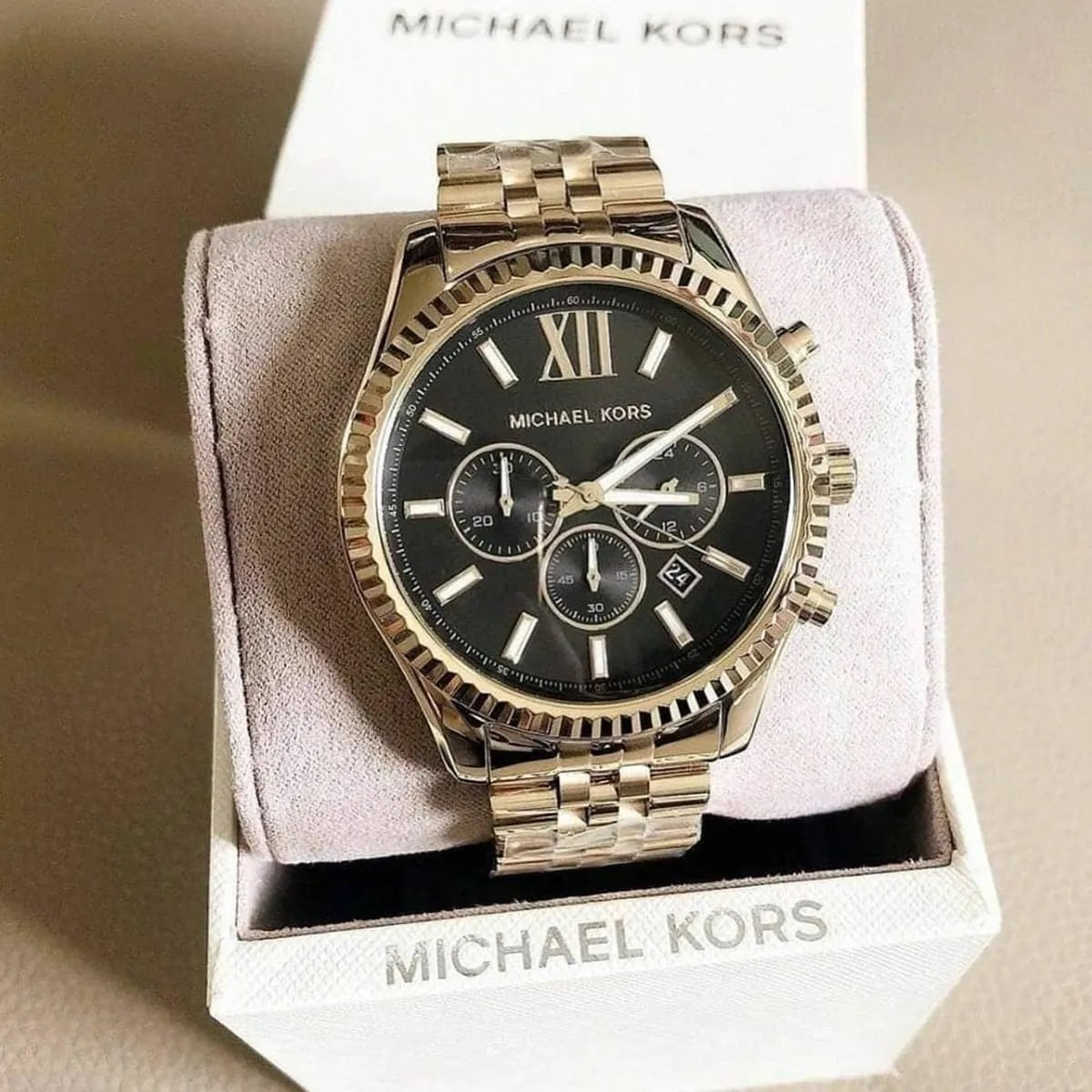 Case and lugs detail on Michael Kors MK8286 men's gold stainless steel watch with black dial