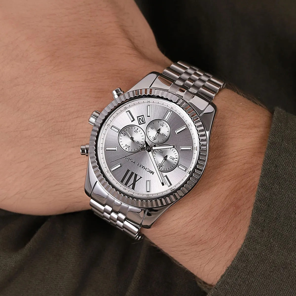 Michael Kors MK8405 men's silver watch with silver dial worn on wrist