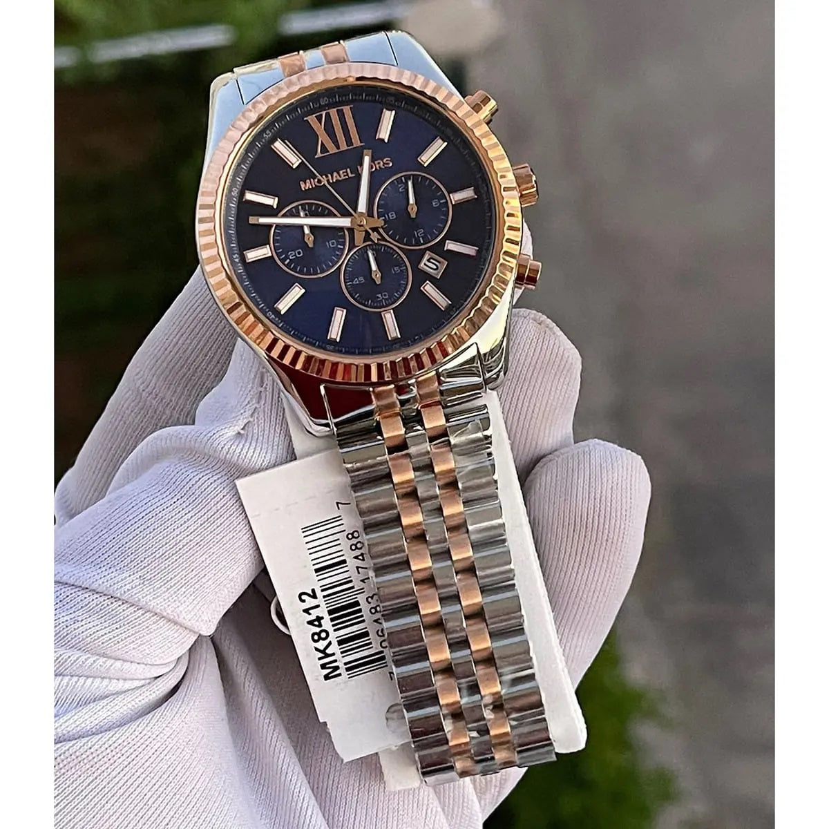 Close-up of dial hands and markers on Michael Kors MK8412 men's blue dial two-tone watch