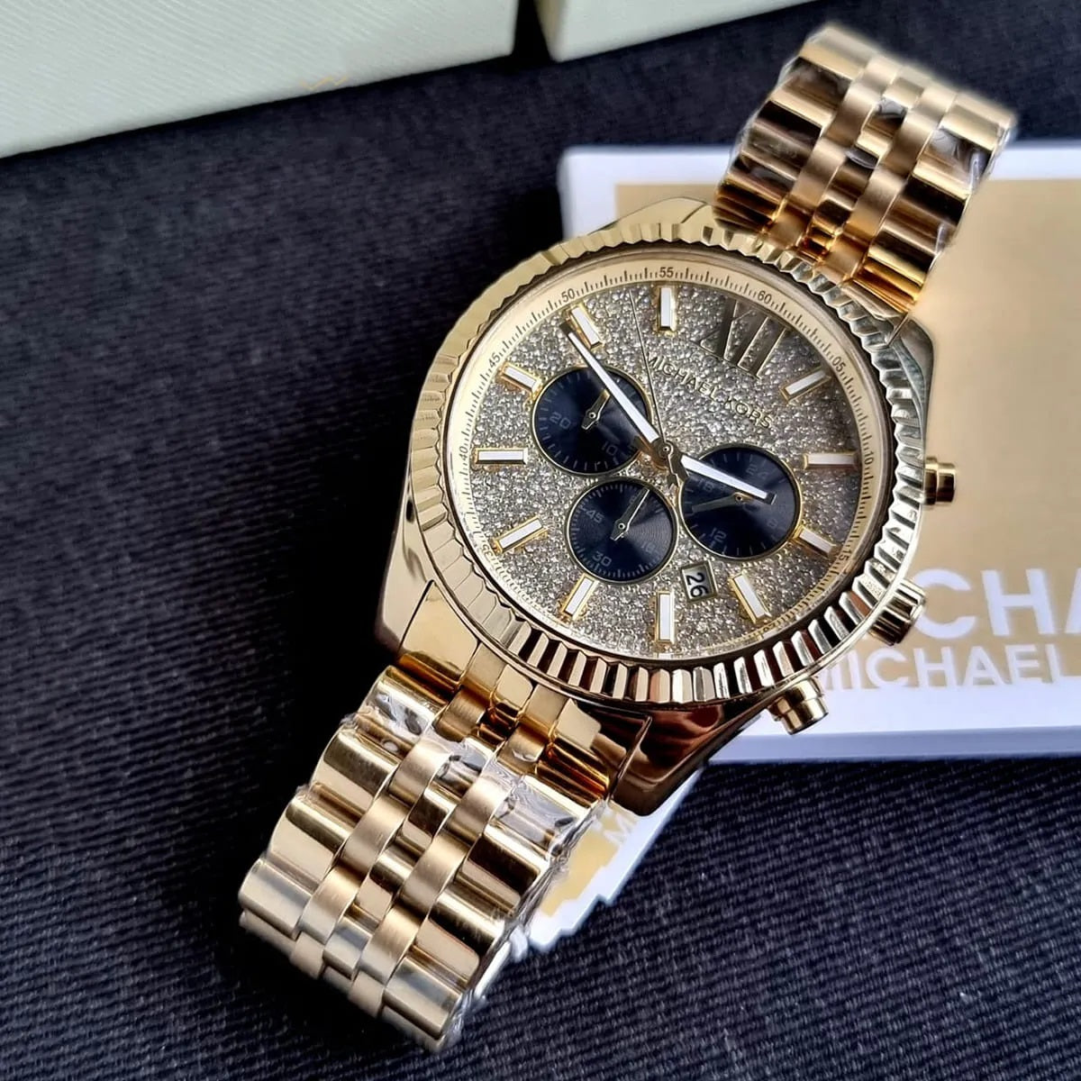 Angled view of Michael Kors MK8494 gold watch with sparkling crystal dial