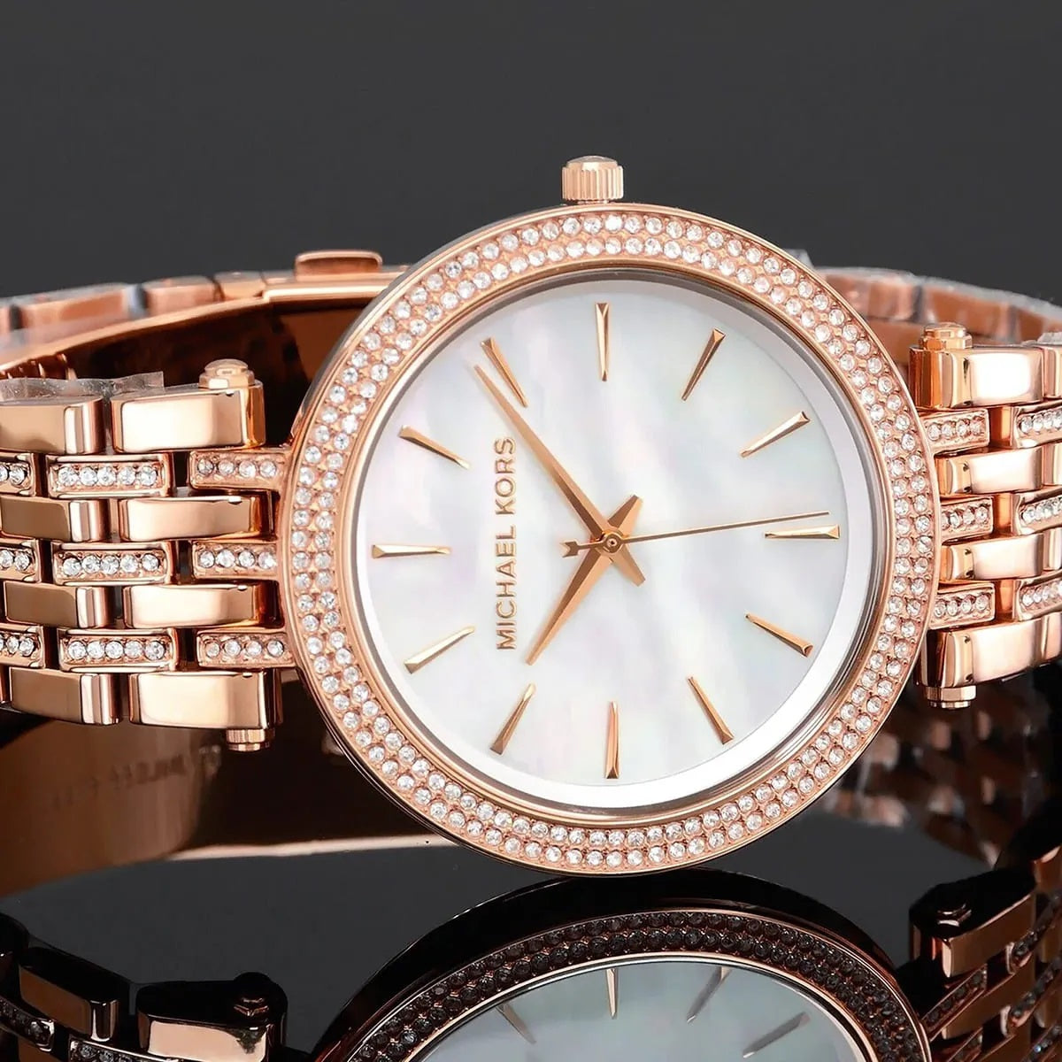 Front view of Michael Kors MK3220 women’s watch with rose gold stainless steel strap and mother of pearl dial with crystals