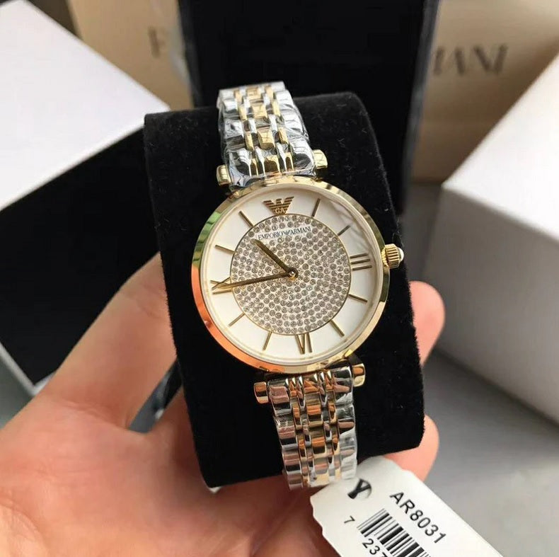 Emporio Armani AR8031 Gianni T-Bar displayed on branded pillow with two-tone strap and white pave crystal dial