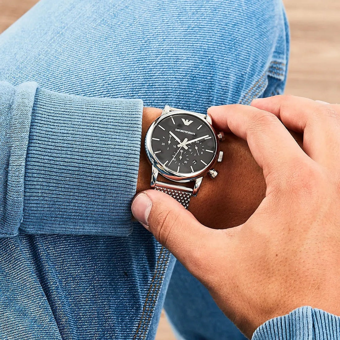 Close wrist view of Emporio Armani AR1811 men’s watch with silver mesh band