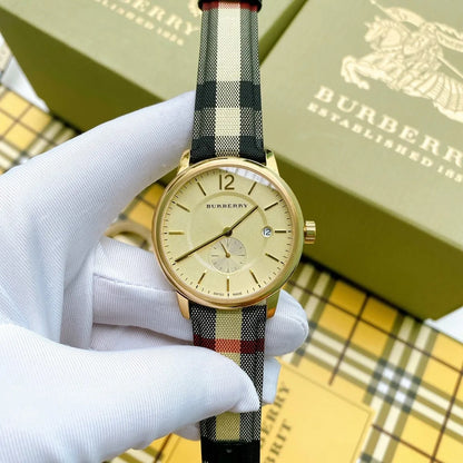 Close-up of gold dial and leather multicolour strap on Burberry BU10001 men's watch