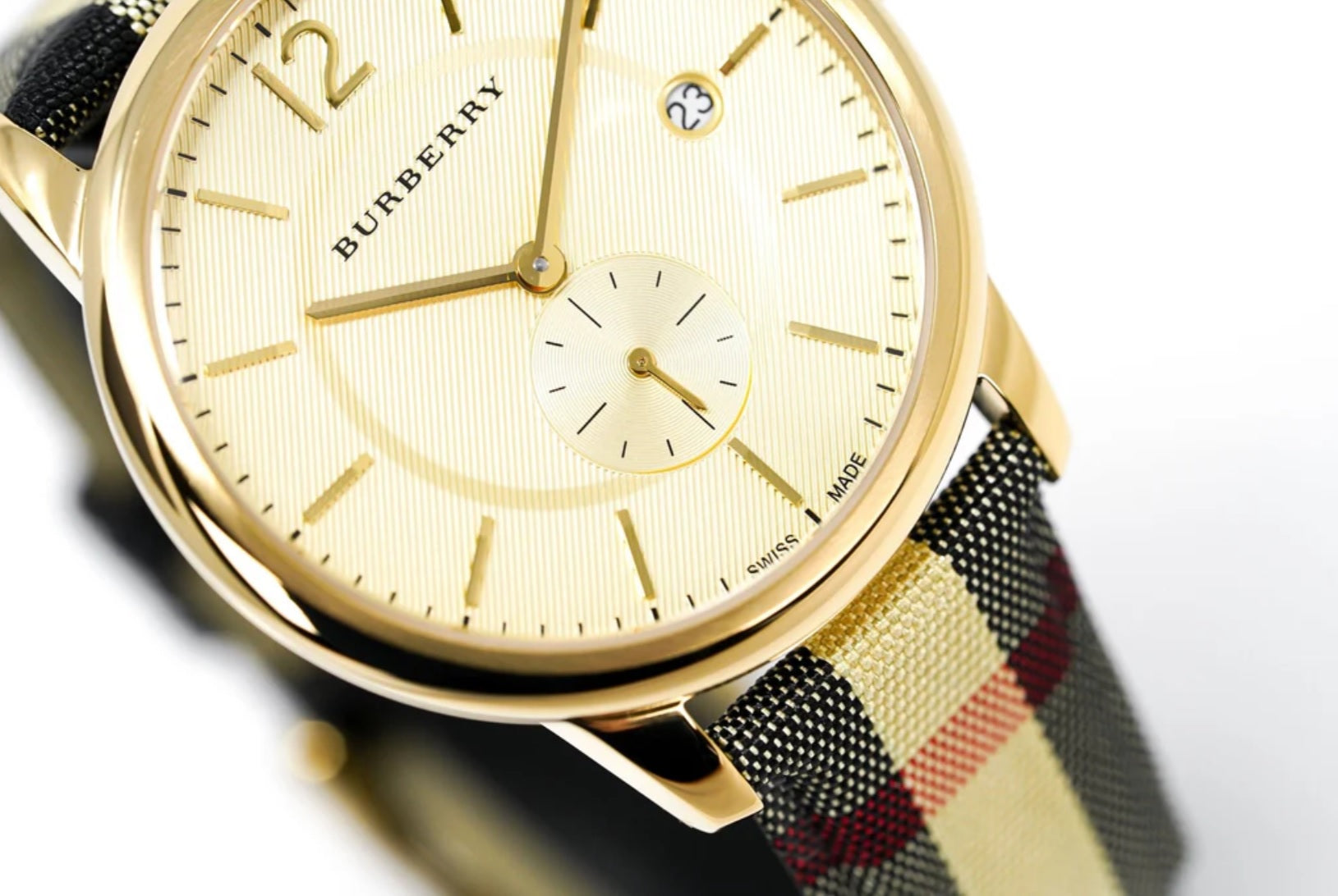 Close-up of Burberry BU10001 men's watch with leather multicolour strap, gold dial, and gold case
