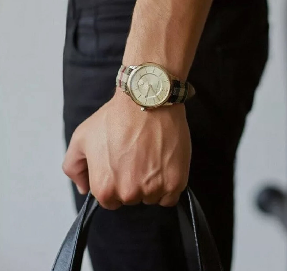Burberry BU10001 men's watch worn on wrist with leather multicolour strap, gold dial, and gold case