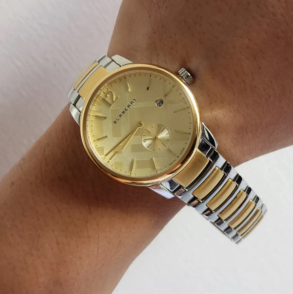 Man wearing the Burberry BU10011 The City two-tone watch on his wrist to demonstrate sizing, fit, and everyday style.