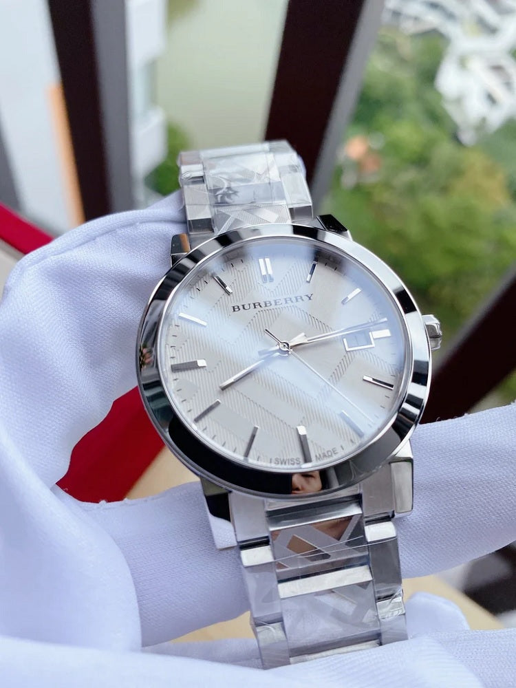 Burberry BU9037 unisex silver stainless steel watch gently held in hands wearing white gloves, showcasing luxury craftsmanship