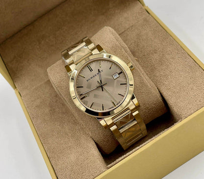 Burberry BU9038 unisex gold watch elegantly displayed in its branded packaging box with luxurious cushion