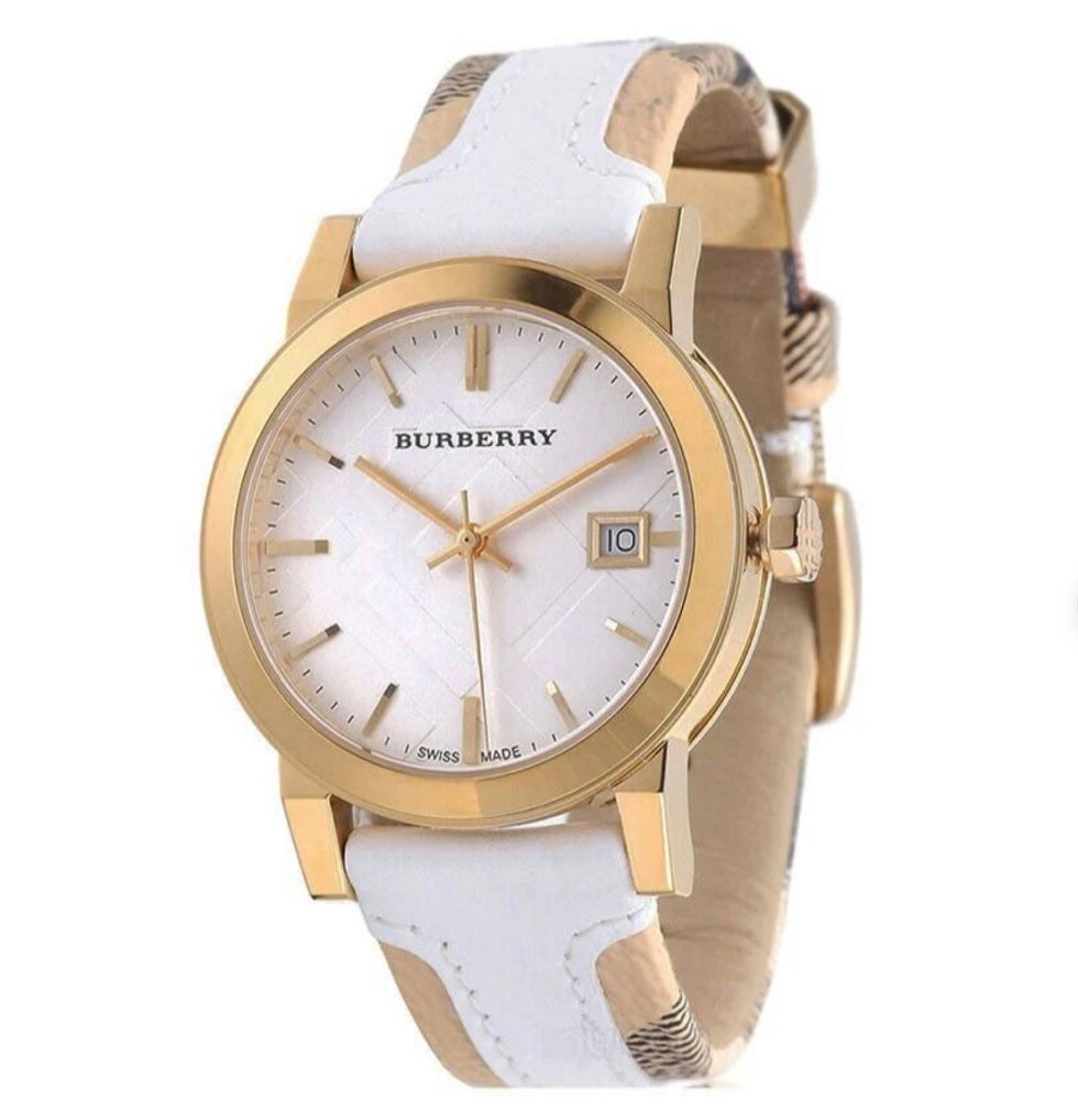 Angled view of the Burberry BU9110 watch highlighting the gold-tone bezel, white dial with date window, and leather strap.