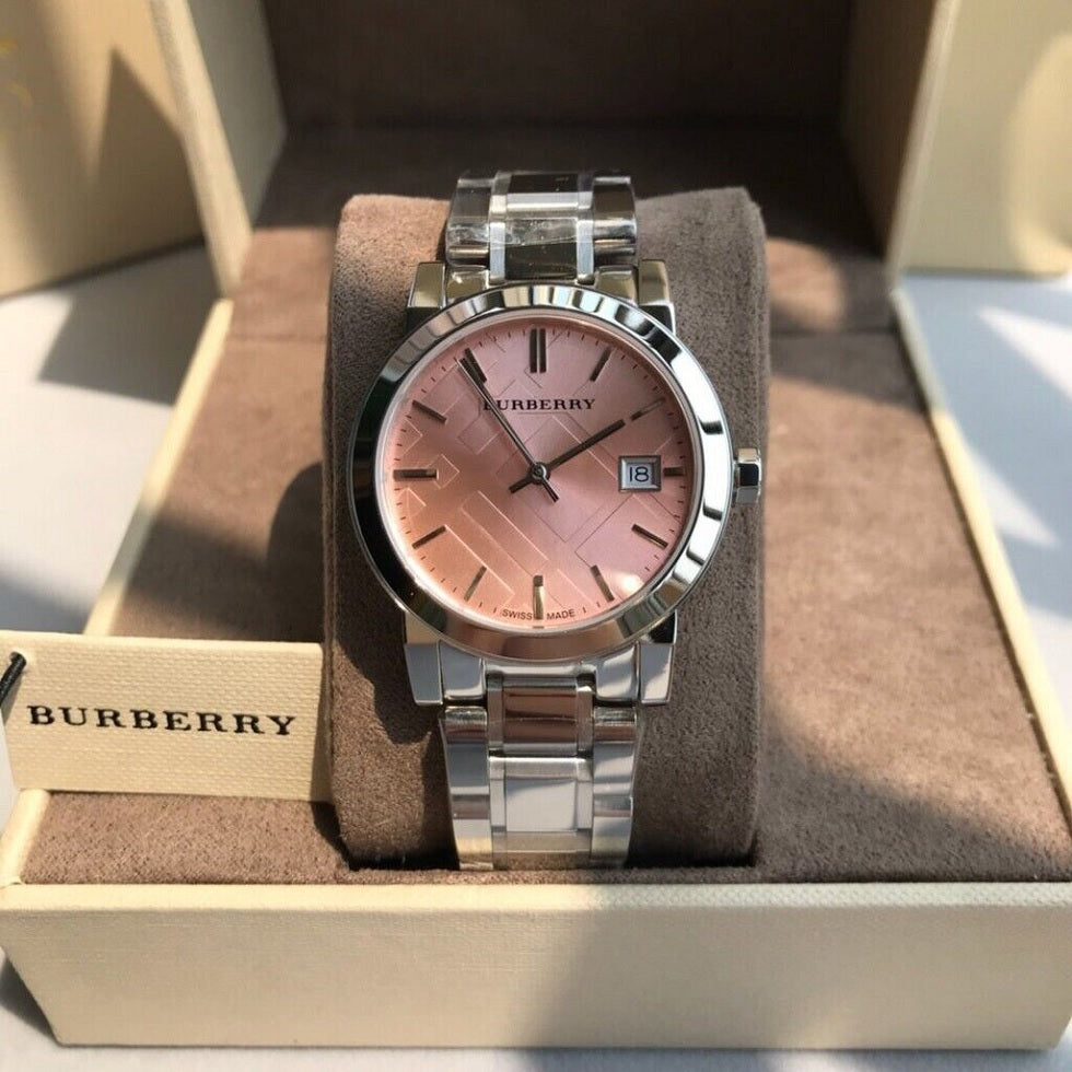 Burberry BU9124 women's silver and pink watch resting on a display cushion inside its presentation box.