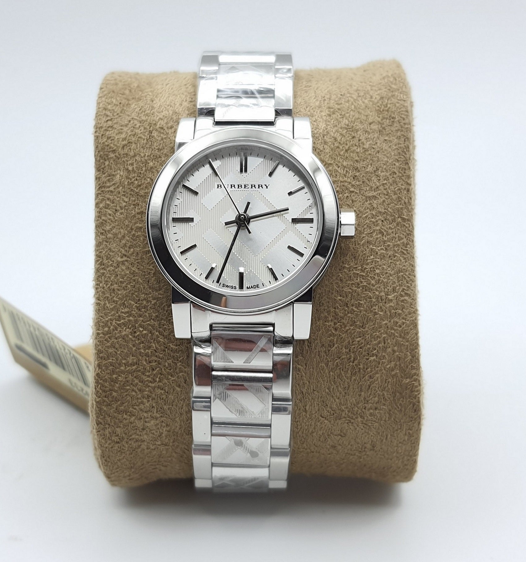 Burberry BU9223 women's silver watch resting on a soft display cushion, showcasing its polished metallic finish and elegant design.