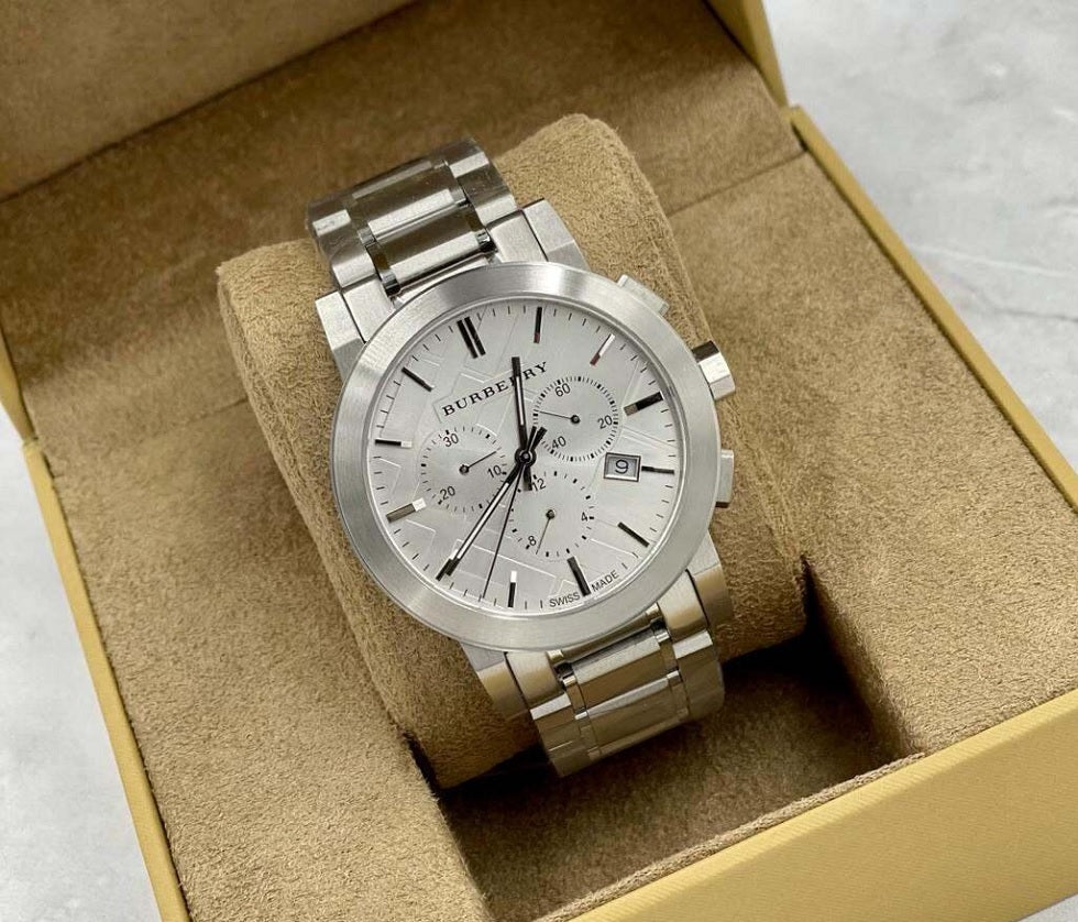Burberry BU9350 The City men’s watch displayed on branded pillow with stainless steel silver strap and silver dial