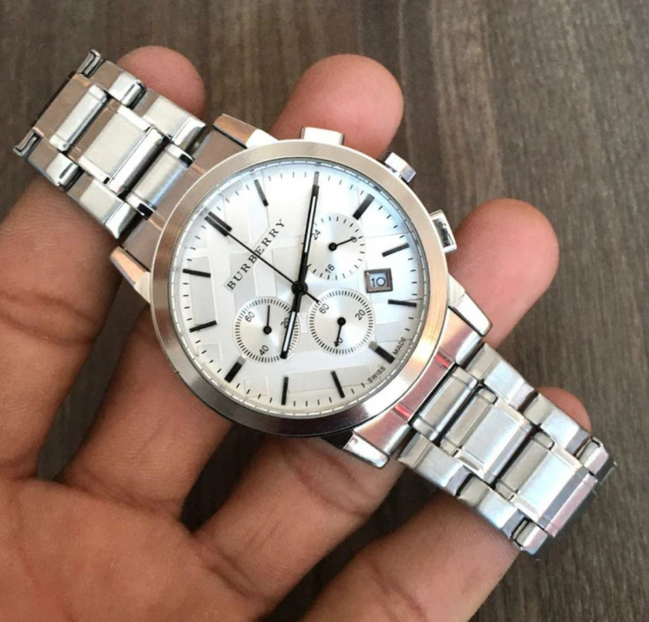 Burberry BU9750 watch held in hands for close inspection