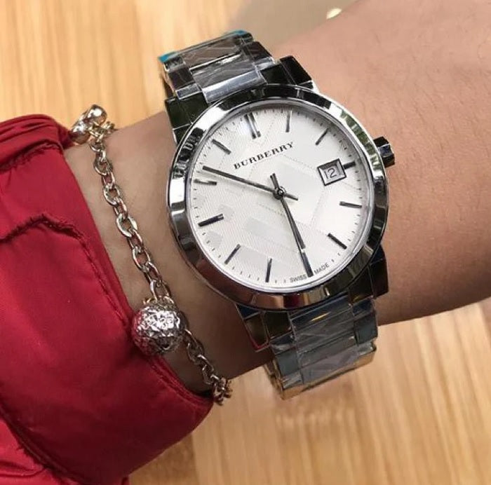 Burberry BU9037 unisex silver stainless steel watch worn on wrist, offering a polished look