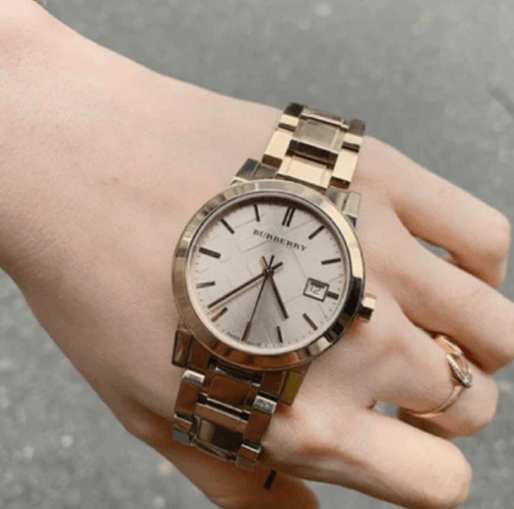 Close-up of polished gold stainless steel bracelet on Burberry BU9134 ladies watch
