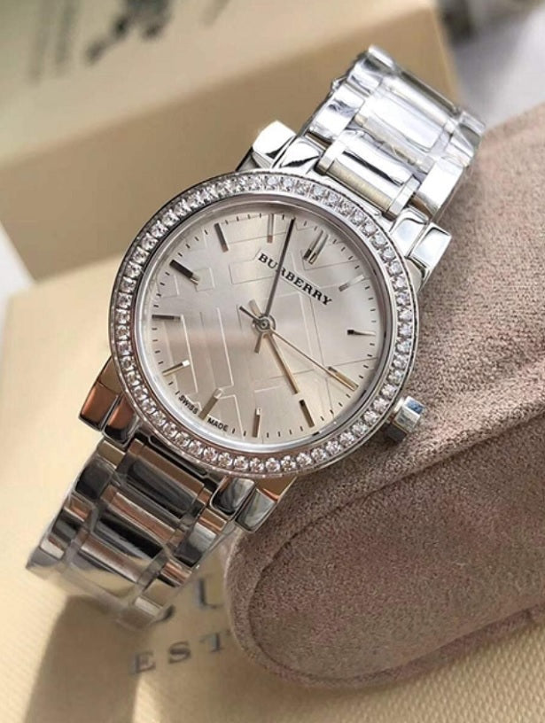 Elegant glamour shot of Burberry Women’s BU9220 silver watch with crystal dial