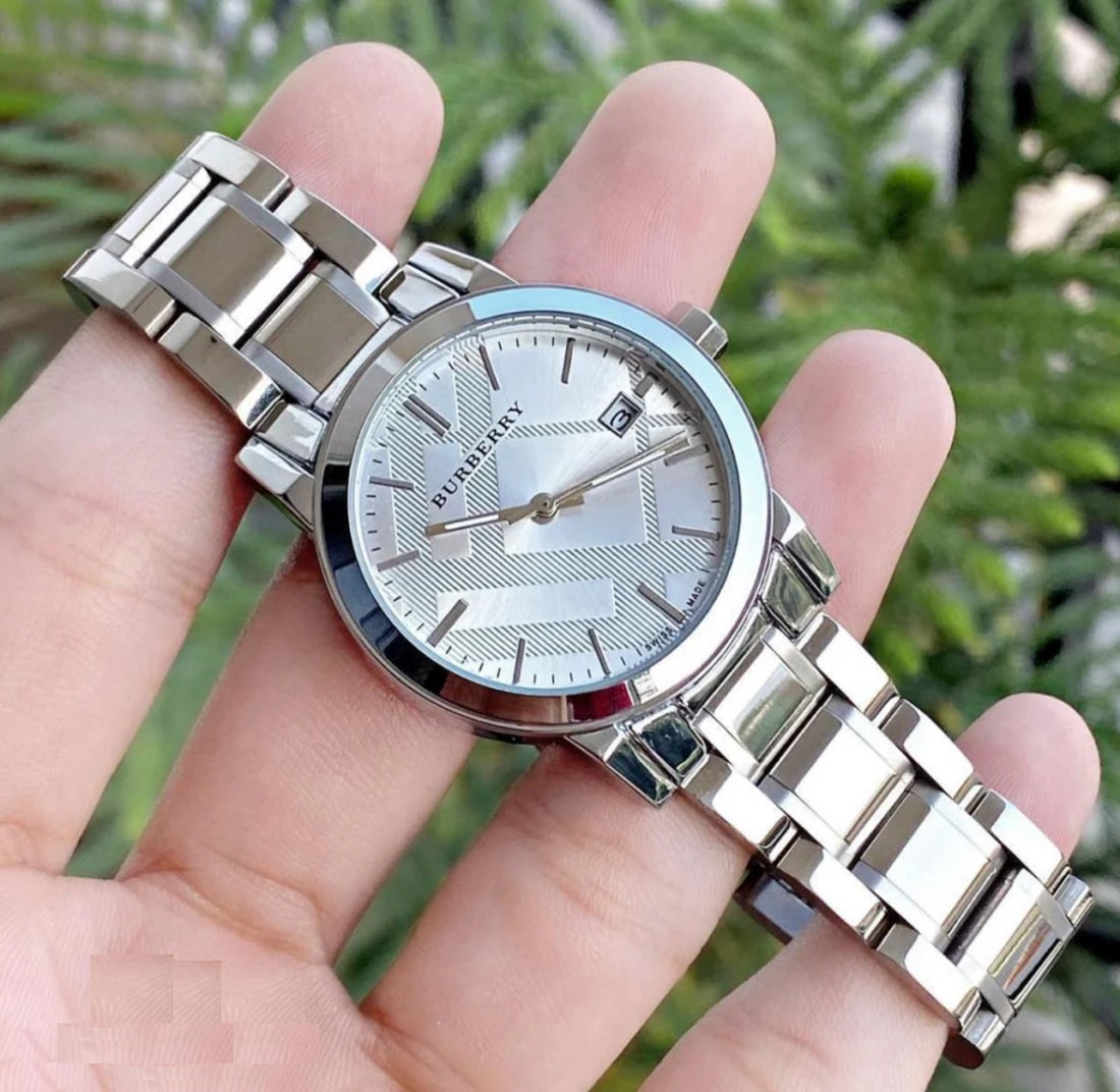 Burberry BU9100 silver women’s watch gently held in hands, showcasing refined craftsmanship and minimalist elegance