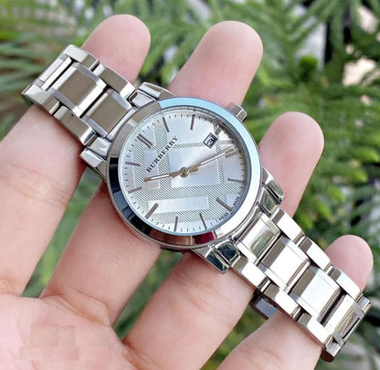 Burberry BU9100 silver women’s watch gently held in hands, showcasing refined craftsmanship and minimalist elegance