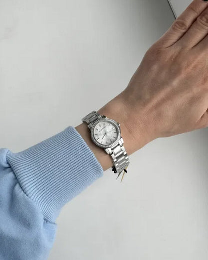 Burberry BU9220 women’s silver watch with crystals shown on wrist in natural daylight
