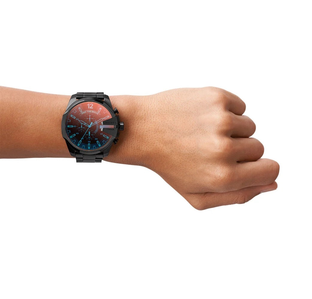 Close-up shot of the Diesel DZ4318 Mega Chief on a man's wrist against a brick background, showing the 51mm case proportions.