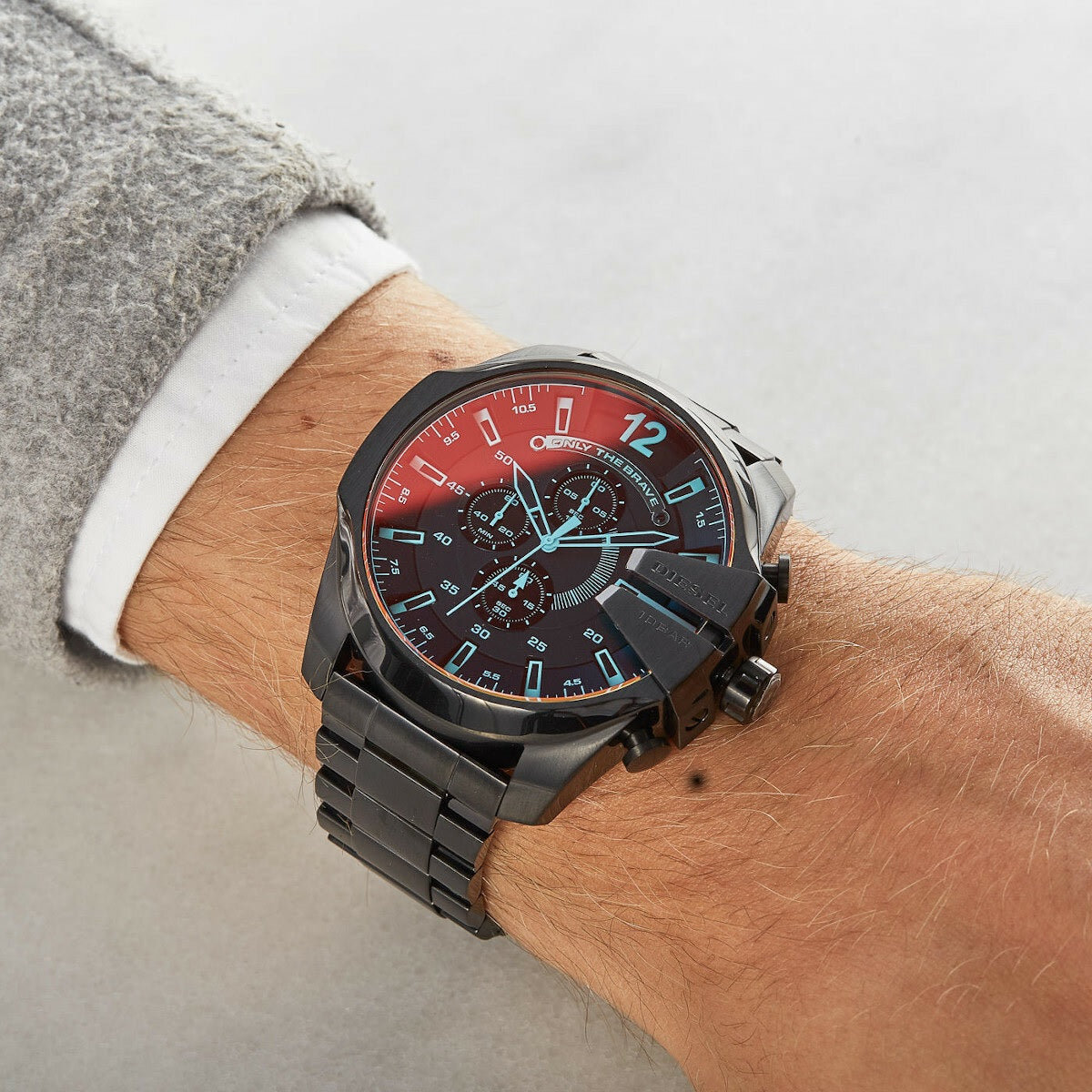 Lifestyle image of a man wearing the Diesel DZ4318 iridescent watch styled with a blue denim shirt for a casual streetwear look.