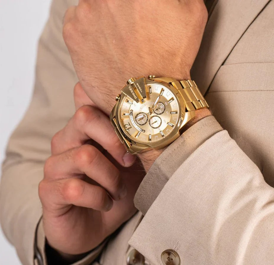 Lifestyle image of a man wearing the Diesel DZ4360 gold Mega Chief watch, styled with a denim shirt for a high-impact streetwear look.