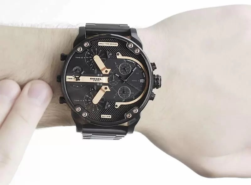 Man wearing the massive 57mm Diesel DZ7312 black and rose gold watch on his wrist, demonstrating its bold streetwear styling and oversized fit.