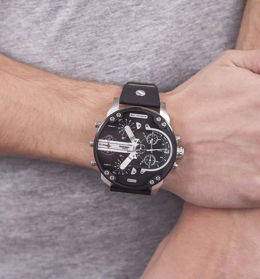 Man wearing the massive 57mm Diesel DZ7313 black and silver watch on his wrist, demonstrating its bold streetwear styling and oversized fit.