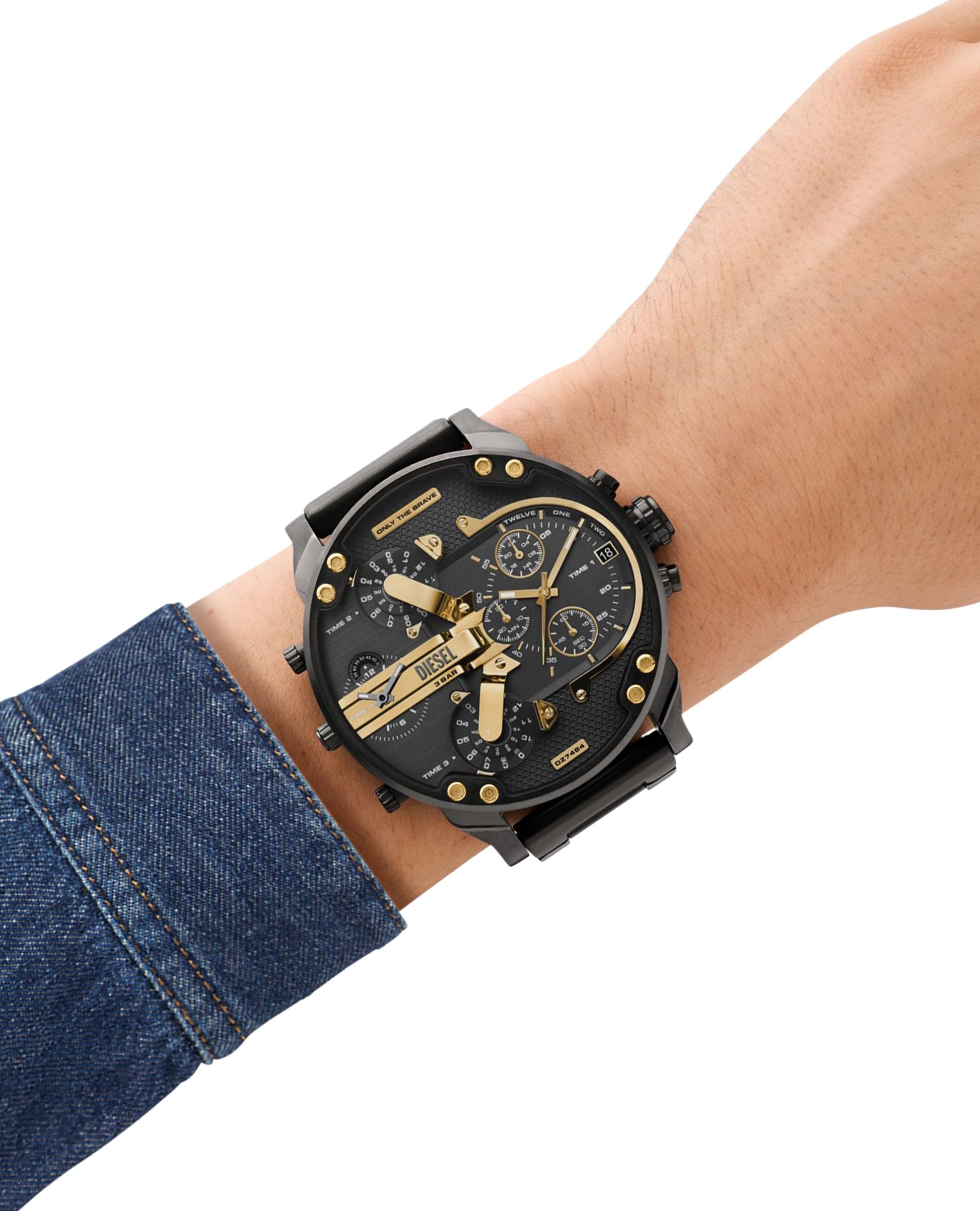 Man wearing the bold Diesel DZ7350 Mr. Daddy 2.0 black leather watch on his wrist, styled with a denim shirt to demonstrate everyday wear.