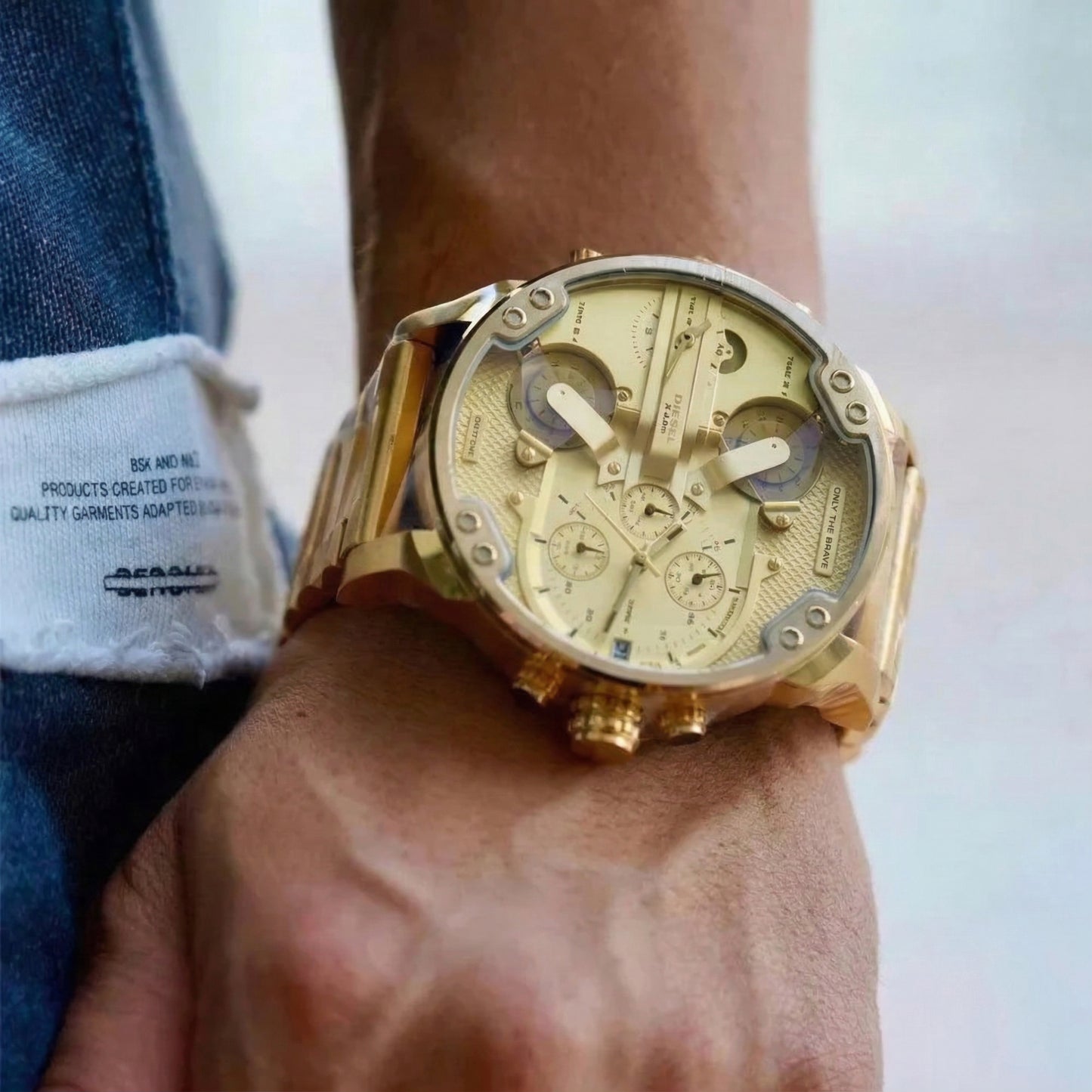 Man wearing the massive 57mm Diesel DZ7399 Mr. Daddy 2.0 gold watch on his wrist to demonstrate its bold, oversized fit and streetwear styling.