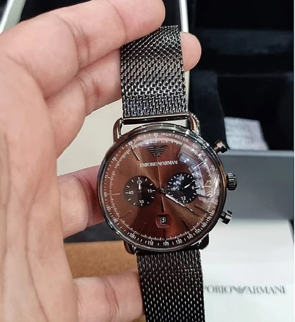 Lifestyle photo of the Emporio Armani AR11141 watch held in hand to show its 43mm size and how the brown dial looks in natural light