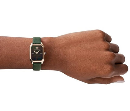 Studio model wrist shot showing the fit and sizing of the Emporio Armani AR11149 green leather watch on a woman's wrist.