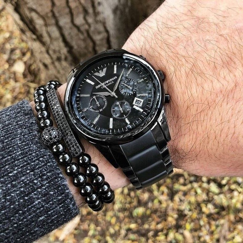 Close-up shot of Emporio Armani AR1452 chronograph worn on wrist, emphasizing black ceramic strap and subdials