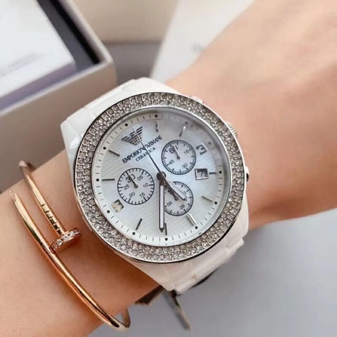 Emporio Armani AR1456 worn on wrist, highlighting the white ceramic strap and mother of pearl dial
