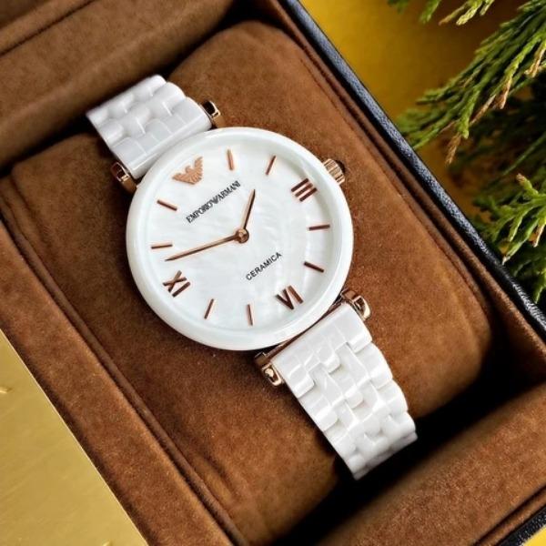 Emporio Armani AR1486 ceramic watch displayed on branded watch pillow