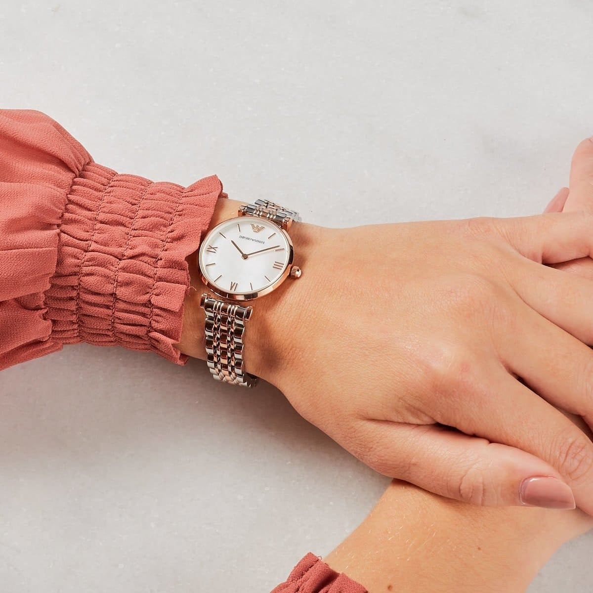 Emporio Armani AR1683 women's watch worn on wrist, silver and rose gold with elegant dial